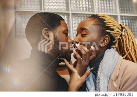 Two young people in cafe. African couple enjoying the time spending with each other. Two young people in cafe. African couple enjoying the time spending with each other. 117936383
