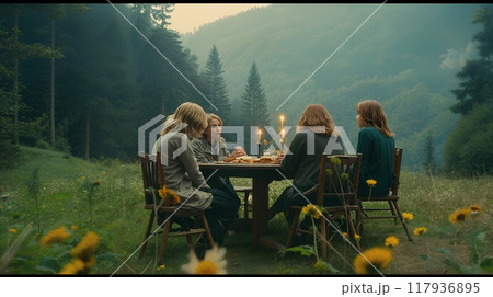 A serene outdoor gathering of friends enjoying a candlelit dinner in a lush forest at dusk surrounded by peaceful nature A serene outdoor gathering of friends enjoying a candlelit dinner in a lush forest at dusk surrounded by peaceful nature 117936895