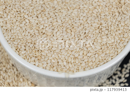 White roasted sesame seeds in a plate. White roasted sesame seeds in a plate. 117939413