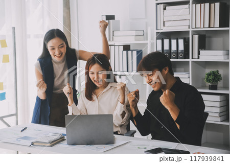 Financial analysts analyze business financial reports on a digital tablet planning investment project during a discussion at a meeting of corporate showing the results of their successful teamwork. 117939841