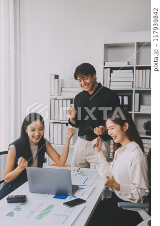 Financial analysts analyze business financial reports on a digital tablet planning investment project during a discussion at a meeting of corporate showing the results of their successful teamwork. 117939842