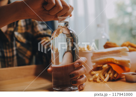 healthy beautiful young woman holding glass of water 117941000