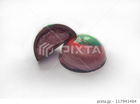 Tempered chocolate candies with a glossy painted body and fruit filling with blur elements 117941484