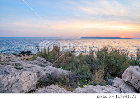 Colorful sunset on Makarska Riviera, popular touristic coastline of the Adriatic Sea in Split-Dalmatia County of Croatia 117941573