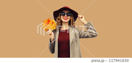 Autumn portrait of beautiful happy smiling woman with yellow maple leaves, stylish joyful girl Autumn portrait of beautiful happy smiling woman with yellow maple leaves, stylish joyful girl 117941830