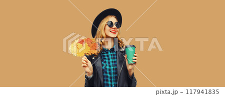Autumn portrait of beautiful smiling young woman with yellow maple leaves, cup of coffee drink Autumn portrait of beautiful smiling young woman with yellow maple leaves, cup of coffee drink 117941835