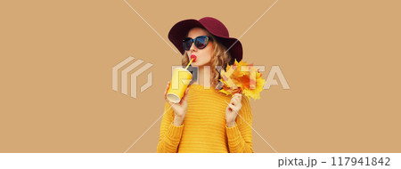 Autumn portrait of beautiful smiling young woman with yellow maple leaves, cup of coffee drink Autumn portrait of beautiful smiling young woman with yellow maple leaves, cup of coffee drink 117941842
