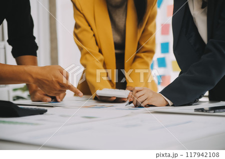 Financial analysts analyze business financial reports on a digital tablet planning investment project during a discussion at a meeting of corporate showing the results of their successful teamwork. 117942108