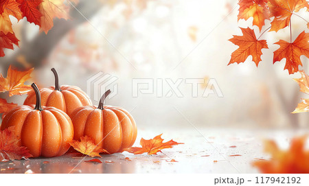 A serene autumn scene with pumpkins and colorful leaves against a soft, blurred background 117942192