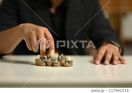 Fingers walking up on stack of coins. Financial growth and investment returns concept Fingers walking up on stack of coins. Financial growth and investment returns concept 117942218
