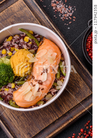 A piece of boiled salmon with rice, broccoli, salt and spices 117942358