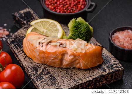 A piece of boiled salmon with rice, broccoli, salt and spices 117942368