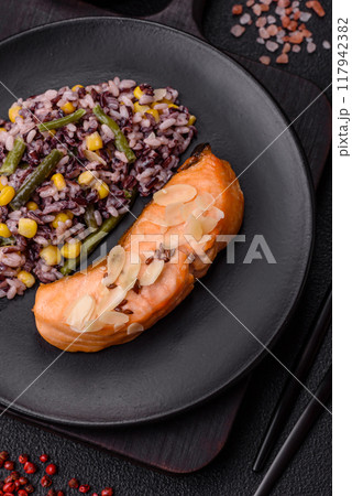 A piece of boiled salmon with rice, broccoli, salt and spices 117942382