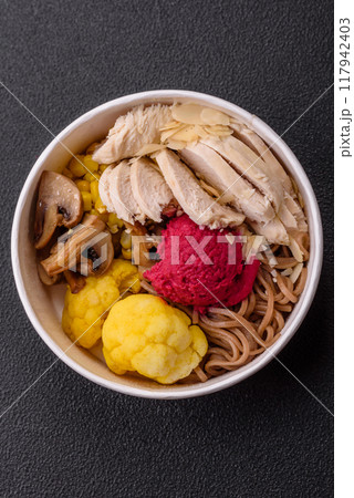 Asian dish with sliced chicken fillet, buckwheat noodles, soy sauce 117942403