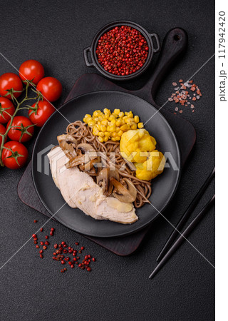 Asian dish with sliced chicken fillet, buckwheat noodles, soy sauce 117942420