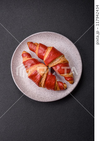 Delicious fresh crispy croissants with chocolate filling 117942434