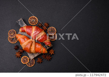 Delicious fresh crispy croissants with chocolate filling Delicious fresh crispy croissants with chocolate filling 117942472