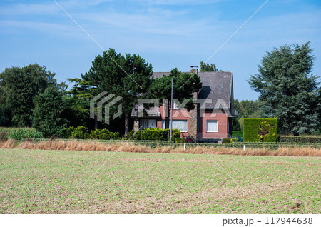 Cultivated vegetables on dry soil and farmhouse, Ternat, Belgium Cultivated vegetables on dry soil and farmhouse, Ternat, Belgium 117944638