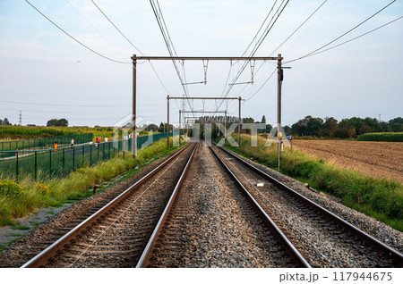 Asse, Flemish Brabant, Belgium - Aug 31, 2024 - Perspective view over double railwaytrack 60 to Dendermonde 117944675