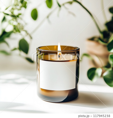 Amber glass candle jar mockup, cylindrical amber candle with blank label, candle burning, cozy sunny bright home interior decor 117945238