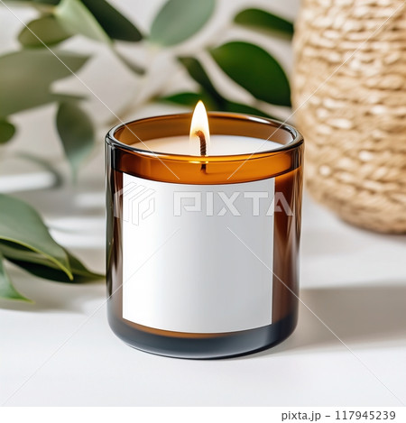 Amber glass candle jar mockup, cylindrical amber candle with blank label, candle burning, cozy sunny bright home interior decor 117945239