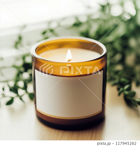 Amber glass candle jar mockup, cylindrical amber candle with blank label, candle burning, cozy sunny bright home interior decor 117945262