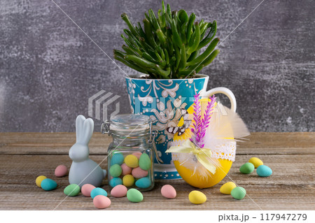 Succulent in a cup, Easter decorated egg, candies and bunny. Succulent in a cup, Easter decorated egg, candies and bunny. 117947279