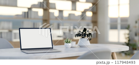 A laptop on a white marble meeting table in a contemporary minimalist meeting room. 117948493