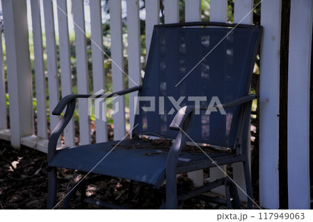 Blue chair by white fence 117949063