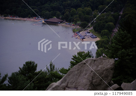 Stone overlook above a popular beach lake 117949085