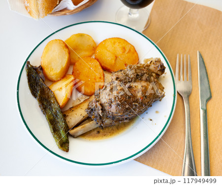 Braised pork knuckle with fried potatoes and baked pepper 117949499