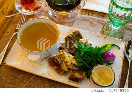 Young bull meat in its own juice with herbs. Khashlama 117949599