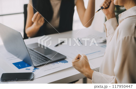 Financial analysts analyze business financial reports on a digital tablet planning investment project during a discussion at a meeting of corporate showing the results of their successful teamwork. 117950447