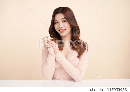 Beautiful young asian woman with clean fresh skin on beige background, Face care, Facial treatment, Cosmetology, beauty and spa, Asian women portrait. 117953488