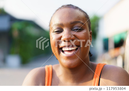 Happy beautiful American - African black ethnicity woman smiling and laughing to camera close up. African black woman expressed her delight emotion. Authentic African woman showing her beautiful smile 117953804
