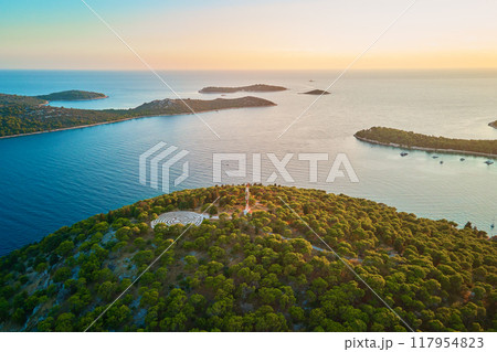 Panoramic view of islands in Adriatic Sea and hedge maze among forest trees at sunset. Lavender labyrinth in Rogoznica, Croatia. Aerial view of coastal landscape. Place for summer vacation 117954823