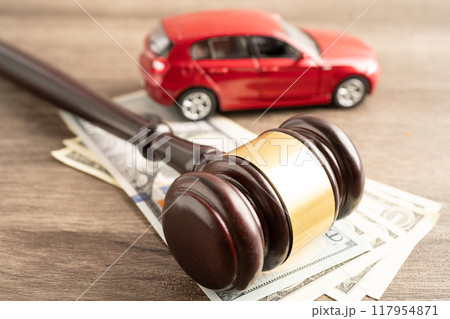 Hammer gavel judge and US dollar banknote money with car vehicle accident, insurance coverage claim lawsuit court case. Hammer gavel judge and US dollar banknote money with car vehicle accident, insurance coverage claim lawsuit court case. 117954871