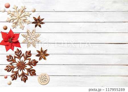 Eco friendly Christmas. Christmas background with retro wooden beads, poinsettia, star anise, snowflake on wooden boards. Copy space for text. Ecology, environmental conservation, zero waste concept 117955289
