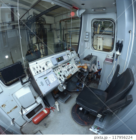 Subway train drivers cabin: seat, dashboard, speed control handle Subway train drivers cabin: seat, dashboard, speed control handle 117956224