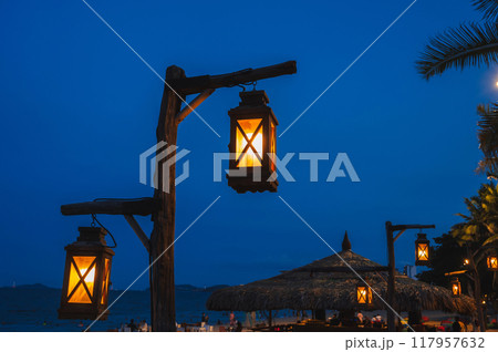 An old street lamp illuminating a dark street An old street lamp illuminating a dark street 117957632