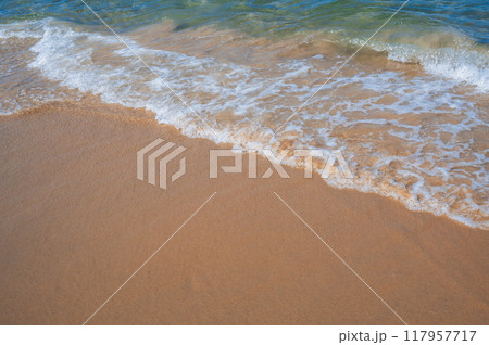 a soft beautiful ocean wave on a sandy beach 117957717