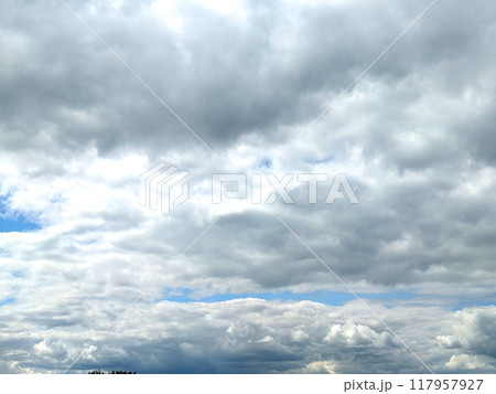Fluffy White Clouds in a Blue Sky as A Skyscape Background Fluffy White Clouds in a Blue Sky as A Skyscape Background 117957927