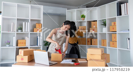Women preparing packages for ecommerce business operations 117958219