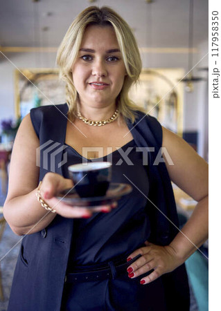 a   middle-aged plus size woman in old money style clothes in a fancy restaurant 117958350