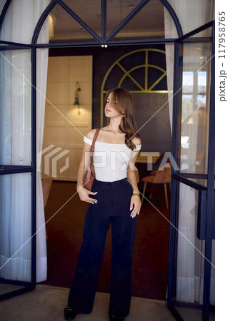 16-year-old teenage girl in old money style clothes in a fancy restaurant 16-year-old teenage girl in old money style clothes in a fancy restaurant 117958765