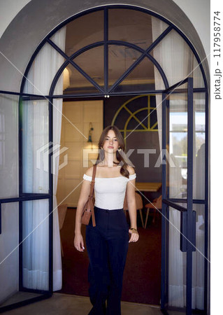 16-year-old teenage girl in old money style clothes in a fancy restaurant 117958774
