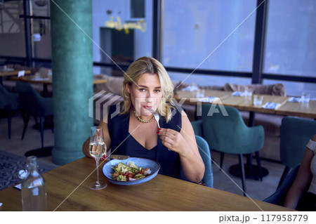 a  middle-aged plus size woman in old money style clothes in a fancy restaurant a  middle-aged plus size woman in old money style clothes in a fancy restaurant 117958779