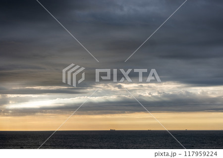 Stormy ocean horizon with dark clouds and turbulent seas creates breathtaking atmosphere Stormy ocean horizon with dark clouds and turbulent seas creates breathtaking atmosphere 117959224