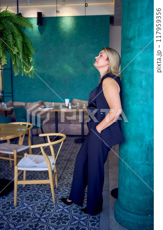 a middle-aged plus size woman in old money style clothes in a fancy restaurant a middle-aged plus size woman in old money style clothes in a fancy restaurant 117959356