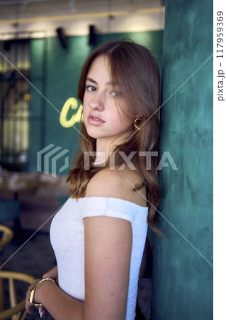 a 16-year-old teenage girl in old money style clothes in fancy restaurant a 16-year-old teenage girl in old money style clothes in fancy restaurant 117959369